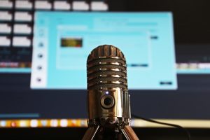 Microphone with computer monitor in background